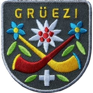 Alphorn Grüezi Aufnäher Grau. Aufnäher von Club of Heroes. Hochwertig gestickte Patches wie Aufbügler Bügelbilder Bügelflicken zur Veredelung von Textilien, zum Aufbügeln oder Aufnähen auf Jacken, Kleidung.
